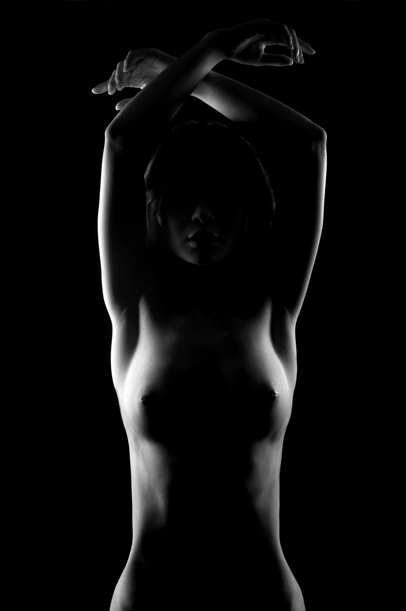 Black and white figure study photography with dramatic light and shadow
